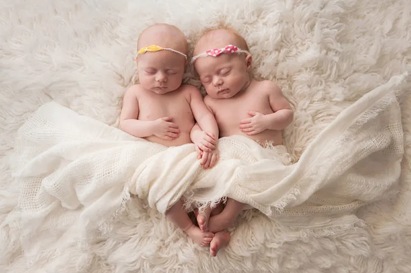 schöne Zwillinge Babys schlafen auf dem Bett