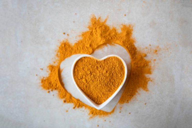 Turmeric powder in a bowl on a table