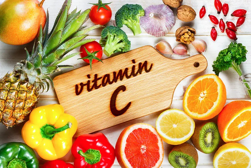 Lebensmittel, die Vitamin C enthalten, und ein Holzschneidebrett mit einem Schild