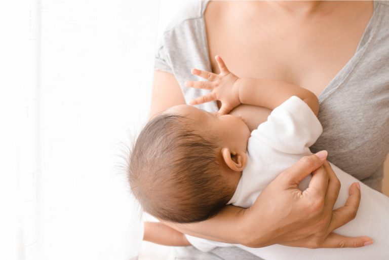 Mutter hält ihr Baby beim Stillen