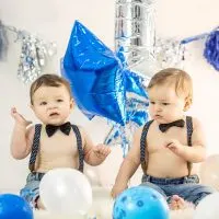 niedlichen Zwillingsbaby Brüder feiern Geburtstag mit Luftballons