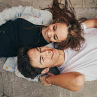 junges Paar auf dem Boden liegend und lachend