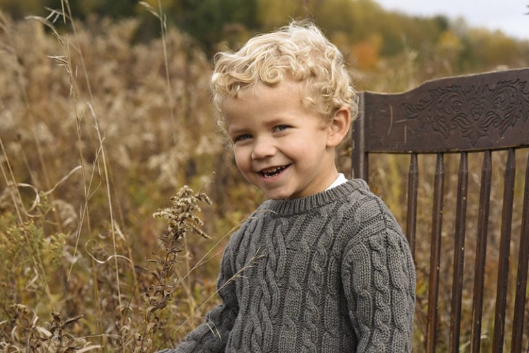 lächelnder Junge mit blonden Locken