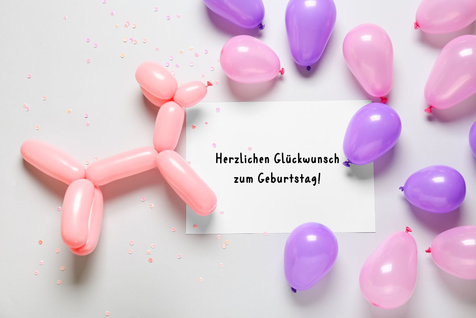 handgeschriebener Geburtstagswunsch neben tierischem Luftballon